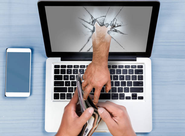 Hand coming out of computer stealing money
