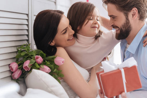 istock Delighted pleasant girl hugging her parents 666273234