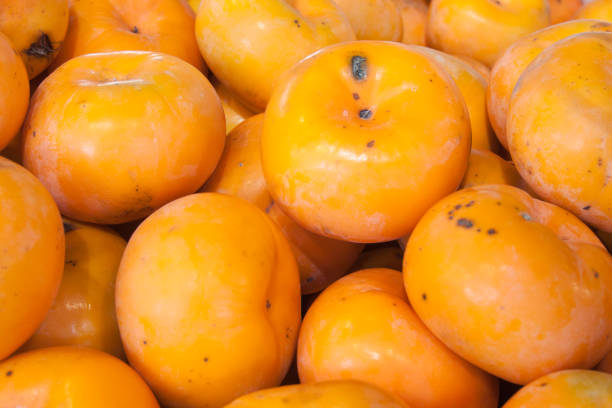 istock Persimmon fruit background in the market 666276130