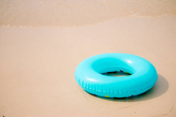 Blue inflatable swim ring on sand beach
