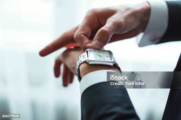 Businessman Adjusts Clock Stock Photo - Download Image Now - Clock, Watch - Timepiece, Men