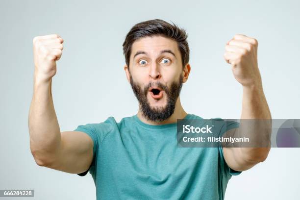 Young Man And Sign Of Victory Isolated On Gray Background Stock Photo - Download Image Now