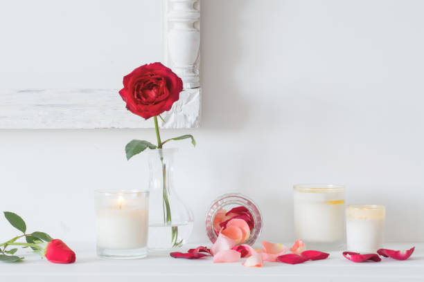 istock roses in a vase and candles on white background 666286652