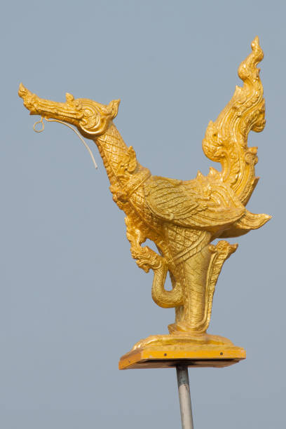 istock Golden swan statue on blue sky background 666286890