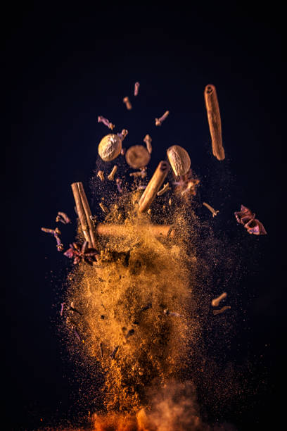 Winter Spice Mix Food Explosion Spice Mix Food Explosion with cinnamon, star anise, cloves, ginger and nutmeg slow motion photos stock pictures, royalty-free photos & images