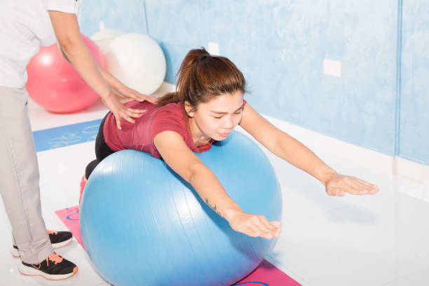istock Asian girl exercising on gym ball 666290224