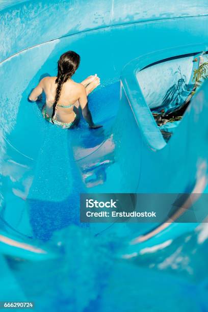 Woman Going Down A Water Slide Stock Photo - Download Image Now - Adult, Blue, Blurred Motion