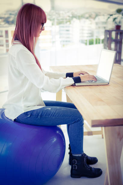 istock Hipster businesswoman using her laptop 666290754