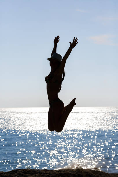 istock woman jumping on the beach 666290952