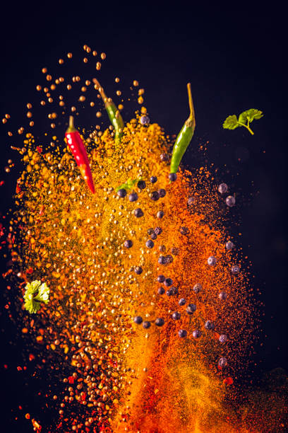 Curry Spice Mix Food Explosion Spice Mix Food Explosion with curry powder, turmeric, coriander, chili and black peppercorns chili pepper photos stock pictures, royalty-free photos & images