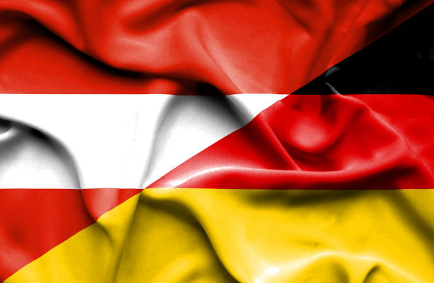 waving flag of germany and austria - austrian flag imagens e fotografias de stock