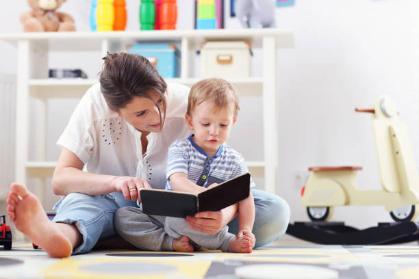 istock Happy mother playing with baby boy at home 666306530