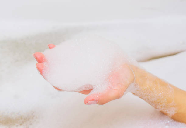 istock Beautiful female hands in white soap. 666311538