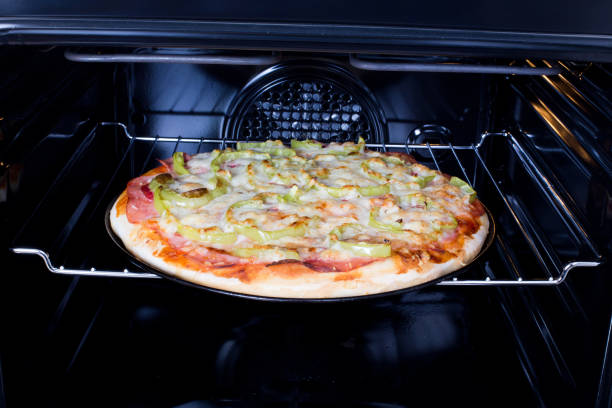 istock Homemade pizza in oven 666314636