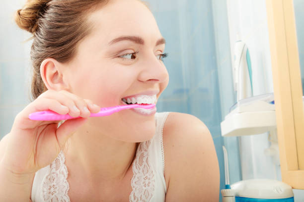 istock Woman brushing cleaning teeth. Oral hygiene. 666314838