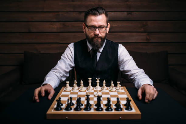 istock Male player against chess board with pieces set 666322358