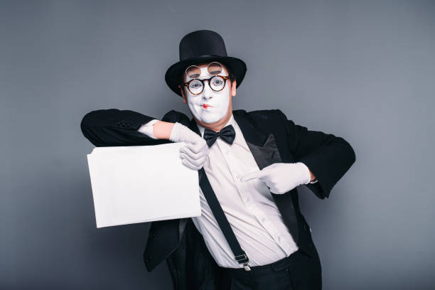 istock Male mime actor with empty paper sheet 666323506