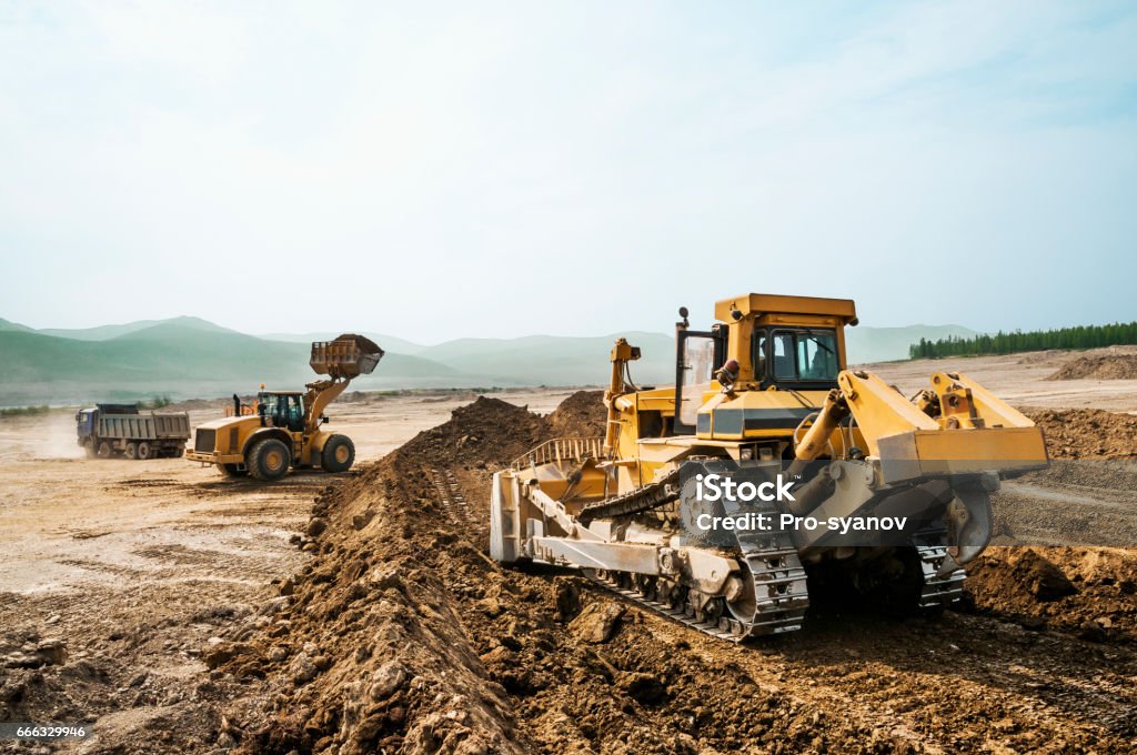 Earthwork, working machinery on a summer day Caterpillar Stock Photo