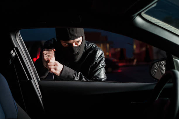 istock Male carjacker open car door with screwdriver 666333044
