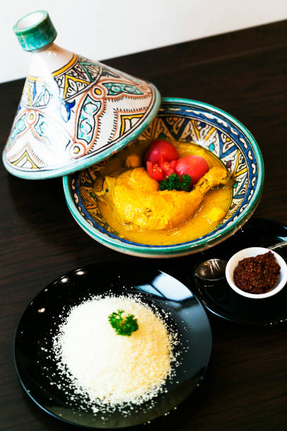 istock Classic Moroccan chicken tagine with Couscous on the wooden table 666336934