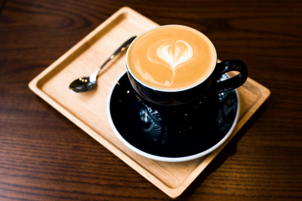 istock Hot latte coffee serve in dark blue cup with love latte art 666337432