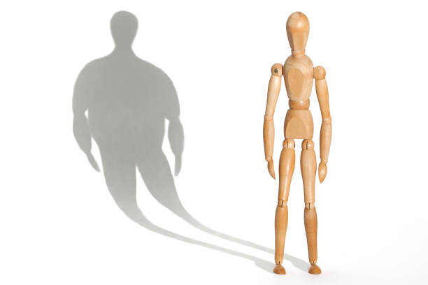 Anorexia Slender mannequin depressed because his distorted fat body shadow bulimia stock pictures, royalty-free photos & images