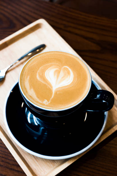 istock Hot latte coffee serve in dark blue cup with love latte art 666339802