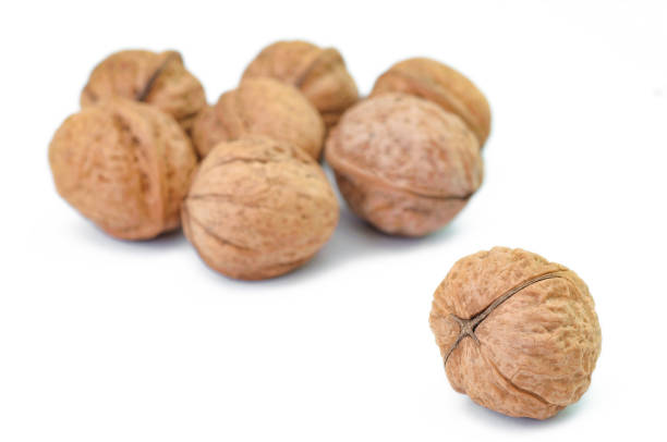 istock Bunch of ripe walnuts isolated on white background 666343200