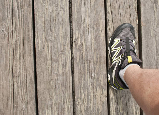 istock Jogger's foot on wooden floor 666346582