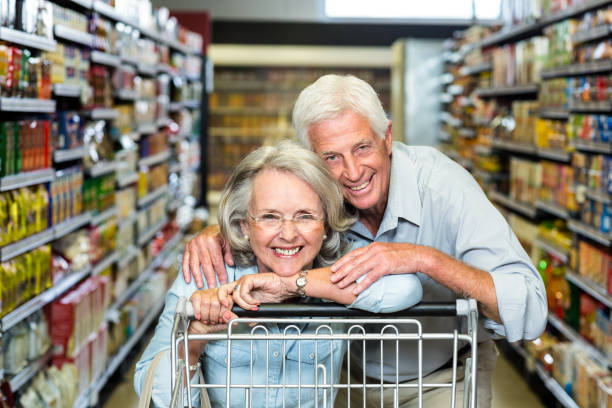 istock Happy senior couple with cart 666356410