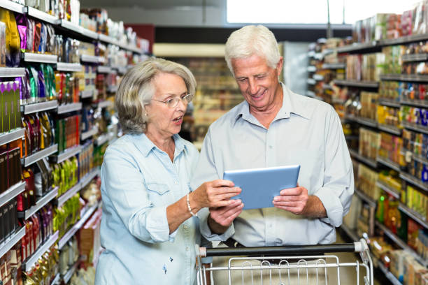 istock Senior couple using tablet at the supermarket 666358772
