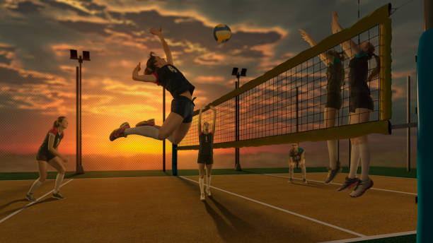 Female volleyball player hitting the ball in the air during the volleyball match on sunset background