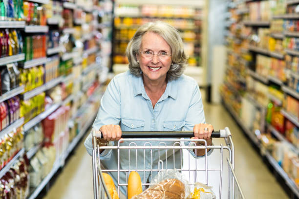 istock Smiling senior woman with cart 666361012