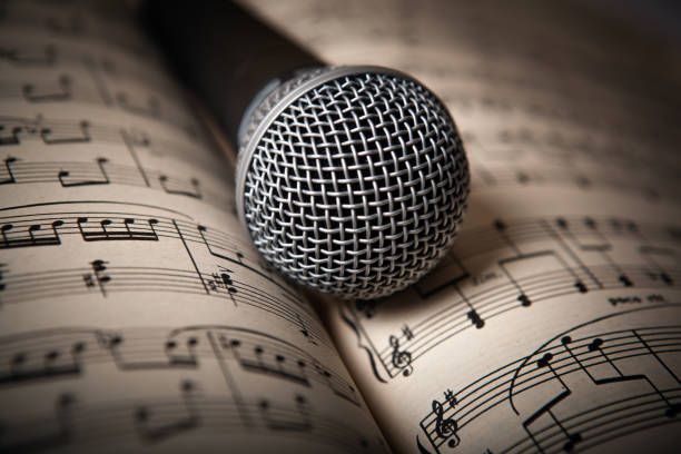 istock microphone lies on the music book 666363112