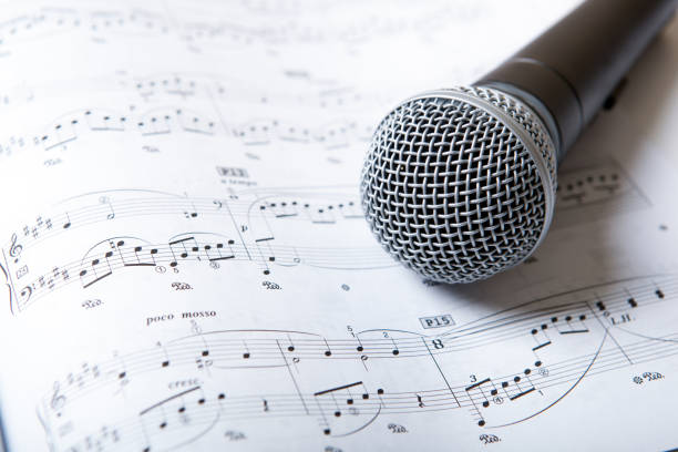 istock microphone lies on the music book 666363188