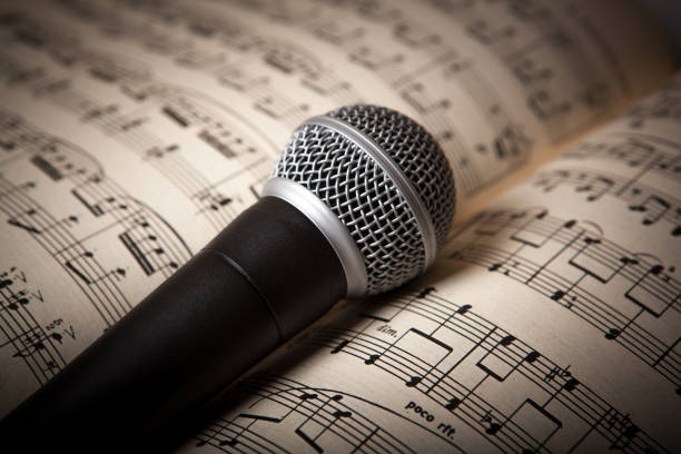 istock microphone lies on the music book 666363212