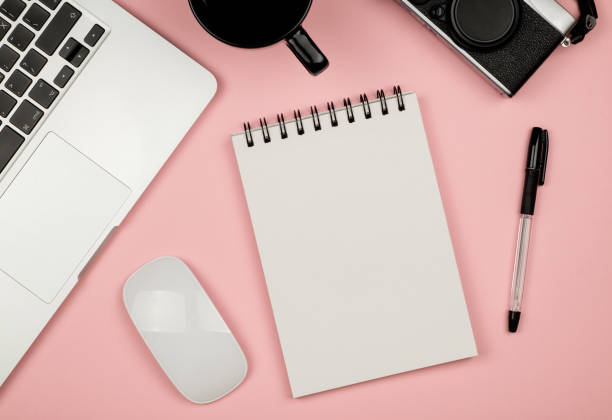 istock Modern office desk table with laptop, blank notebook page for input the text in the middle and other supplies. Top view, flat lay 666366698