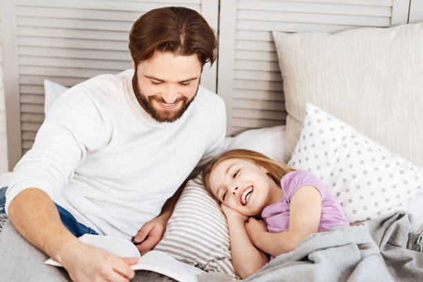 istock Joyful little daughter going to sleep 666371186