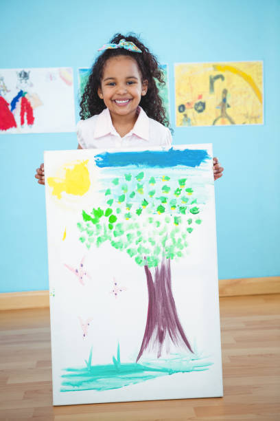 istock Cute girl showing her drawing 666372448