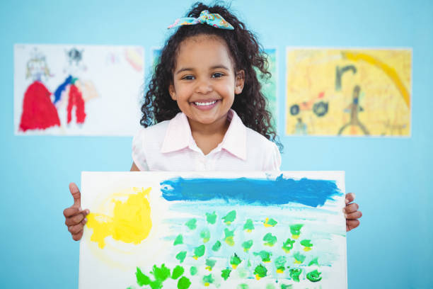 istock Cute girl showing her drawing 666372570
