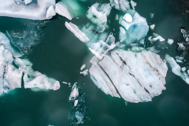 Jokulsarlon Lagoon, Iceland Aerial view of icebergs floating in Jokulsarlon Lagoon by the southern coast of Iceland. Soft focus. Image taken with action drone camera causing distortion and blur. icecap photos stock pictures, royalty-free photos & images