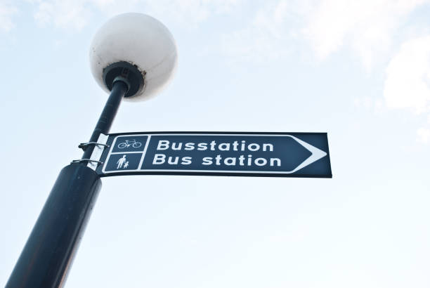 istock Street lamp post with direction sign to bus station (swedish) 666375376