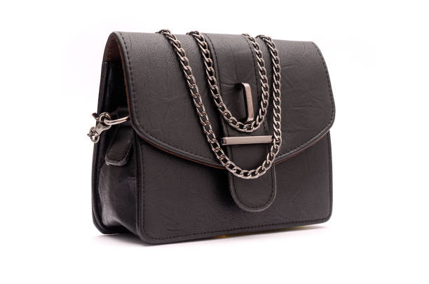 istock Black leather clutch with chain isolated on white 666379410