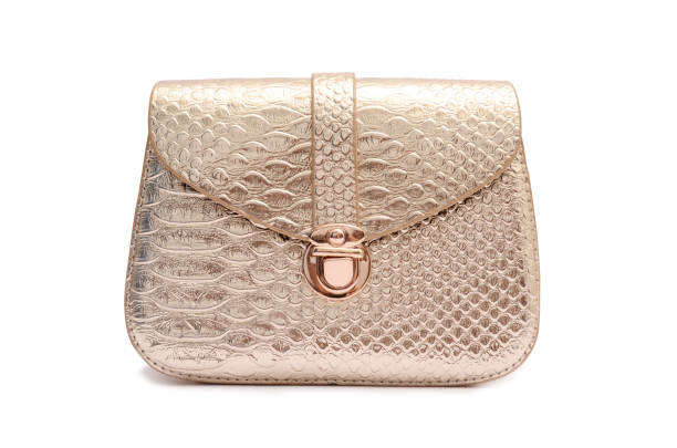 istock Golden leather clutch isolated on white 666379510