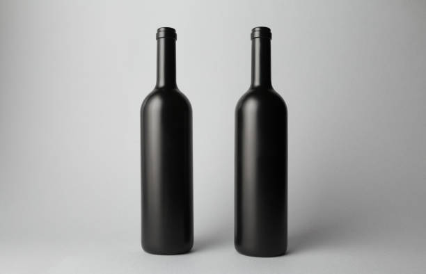 istock Two wine bottles are standing on gray background 666379636
