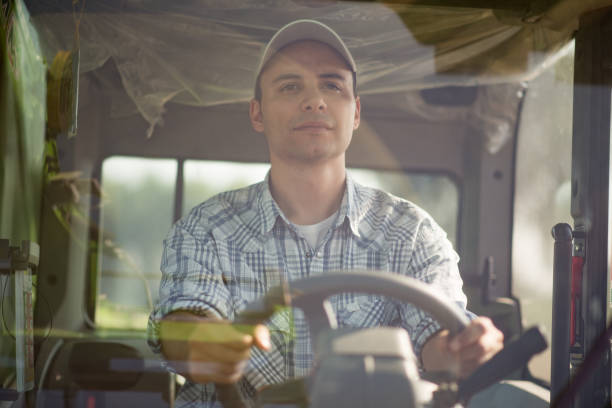 istock Farmer driving a tractor in his field 666380380