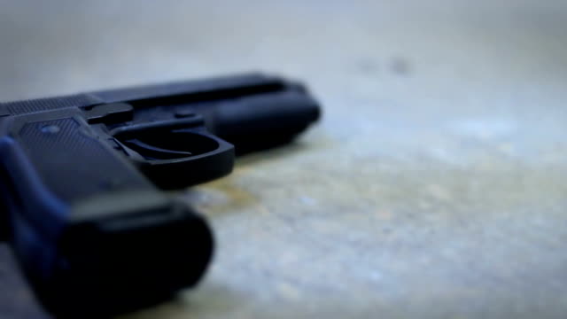A handgun or pistol lying on grunge basement floor