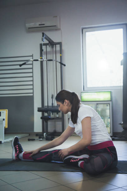 istock Attractive young woman is doing plank exercise while working out in gym 666383786