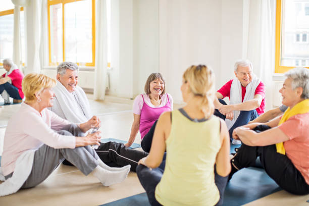 istock Senior friends talking to instructor at yoga class 666387704