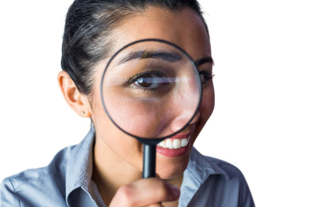 istock Woman examining with a magnifying glass 666388414